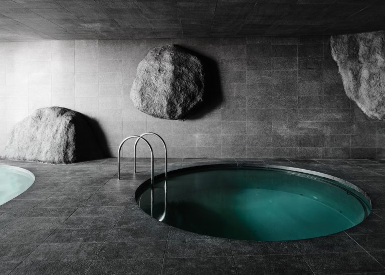 desain kolam renang bulat nuansa gua dengan batu alam granite